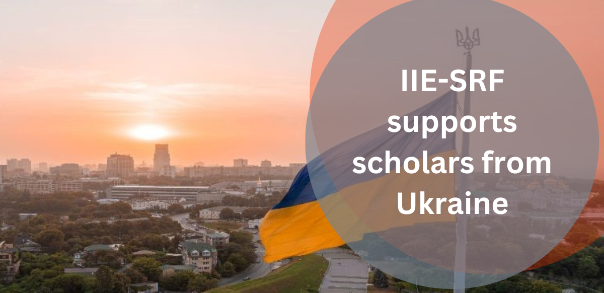 Slider image that says IIE-SRF supports scholars from Ukraine. Image is of Ukrainian flag flying over a city at sunset